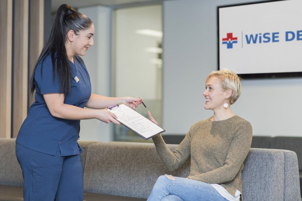 An image of a nurse handing over the form for discounts and promotions for treatments