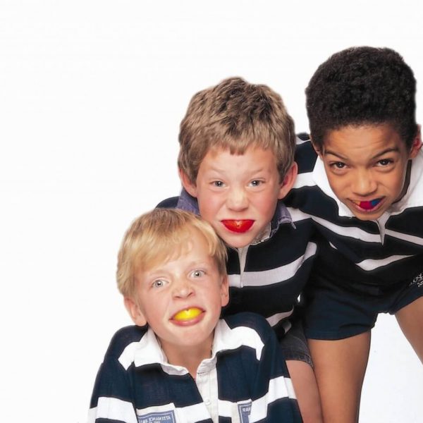 Three kids with navy blue color t-shirt and short paint and mouthguard in the mouth